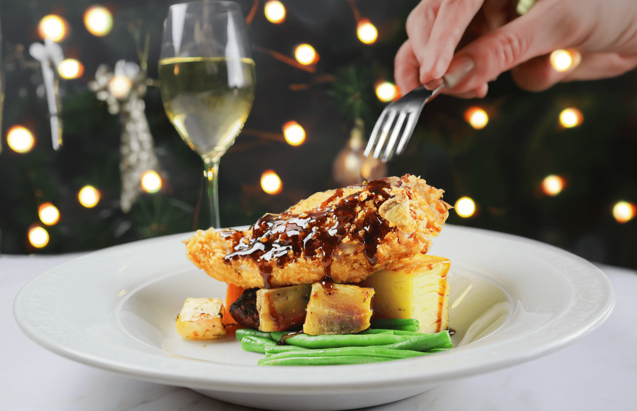 A close up photograph of a plate of food and champagne glass.